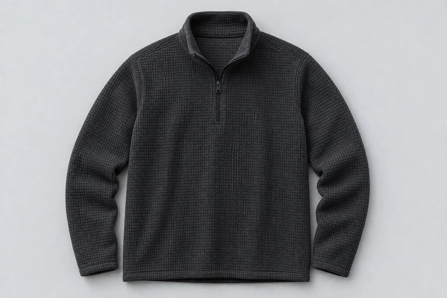 Grid fleece laid flat on a plain studio background, photographed from above