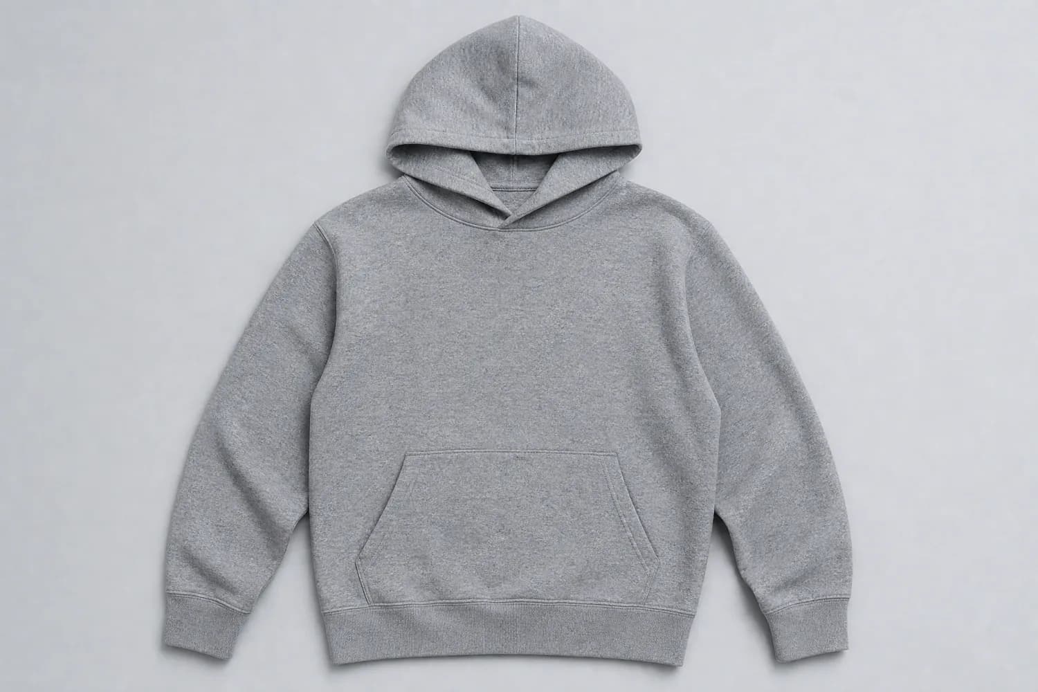 Cotton hoodie laid flat on a plain studio background, photographed from above