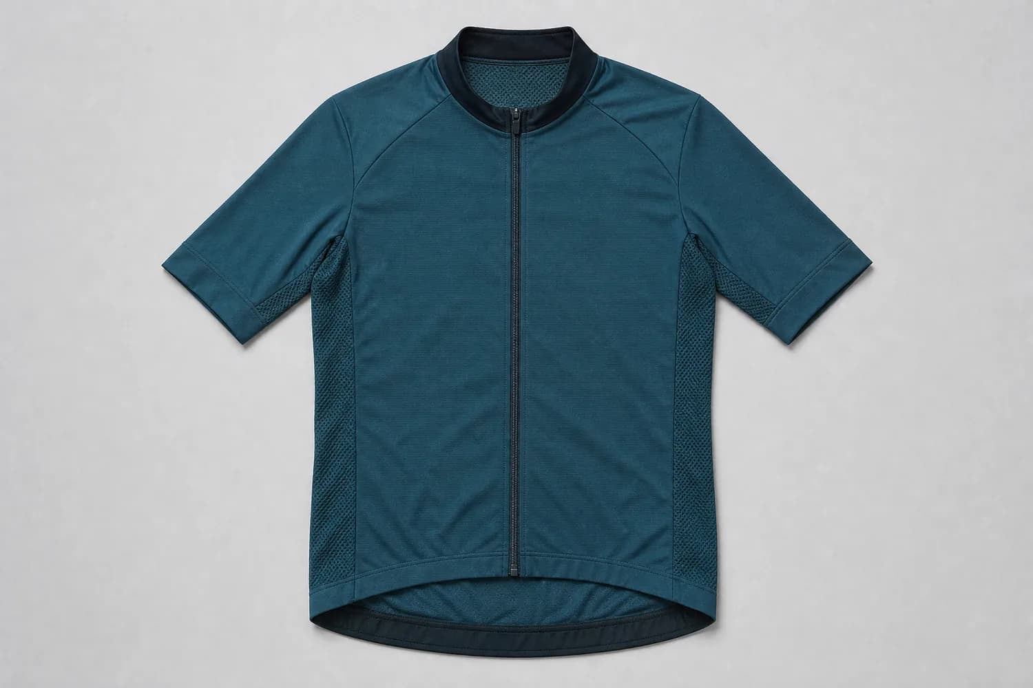 Cycling jersey laid flat on a plain studio background, photographed from above