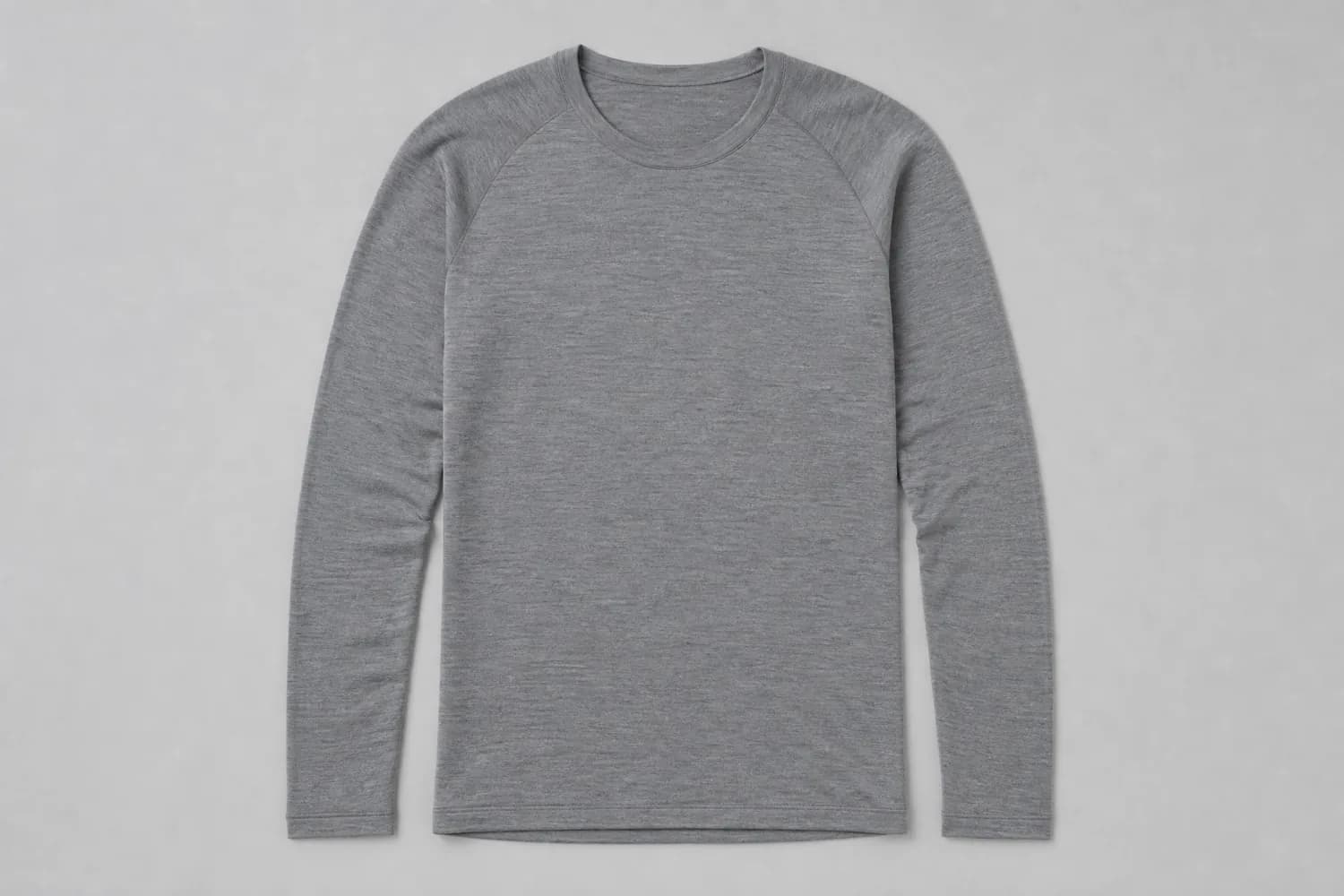 Merino long sleeve laid flat on a plain studio background, photographed from above