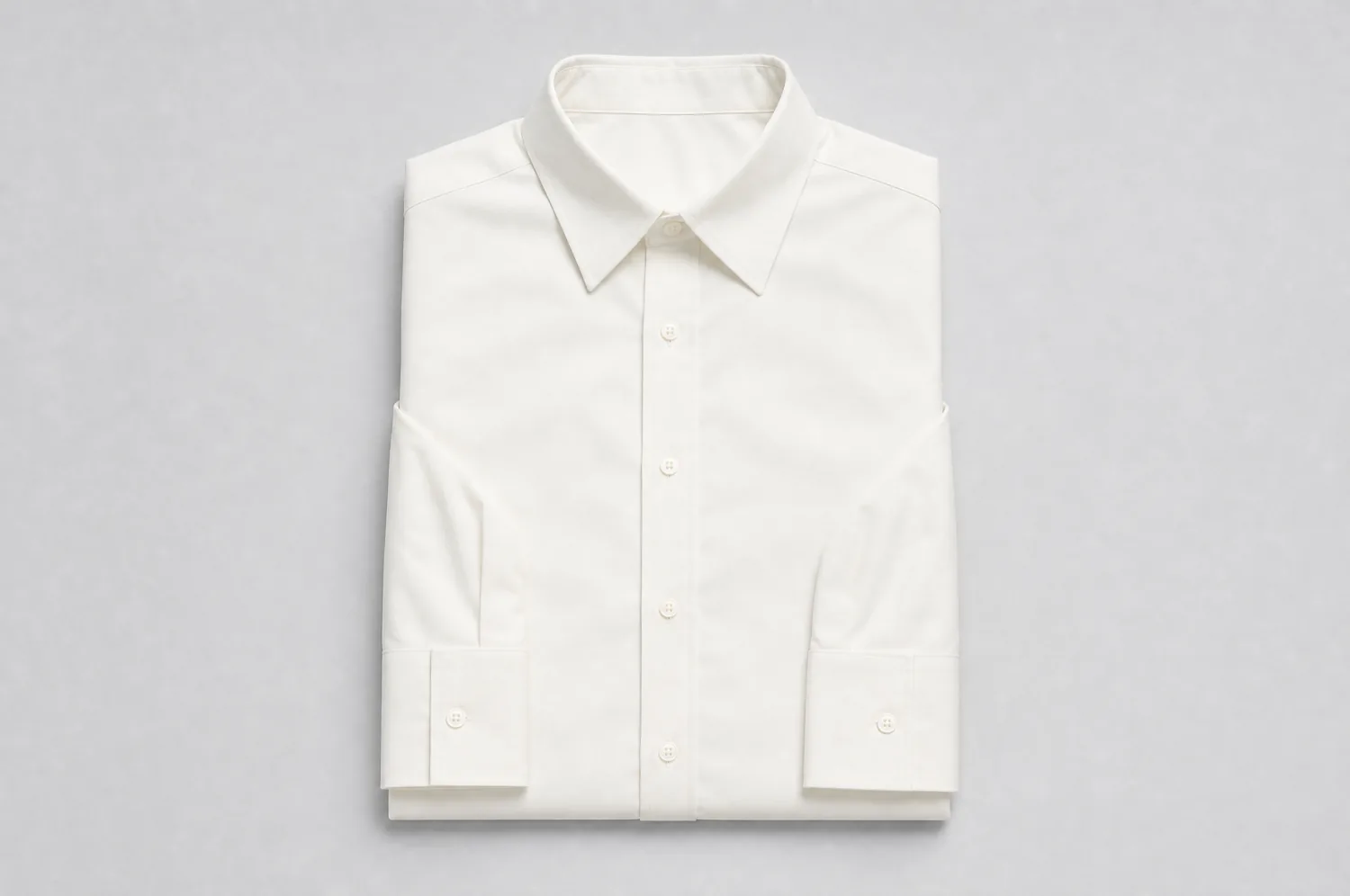 Cotton shirt laid flat on a plain studio background, photographed from above